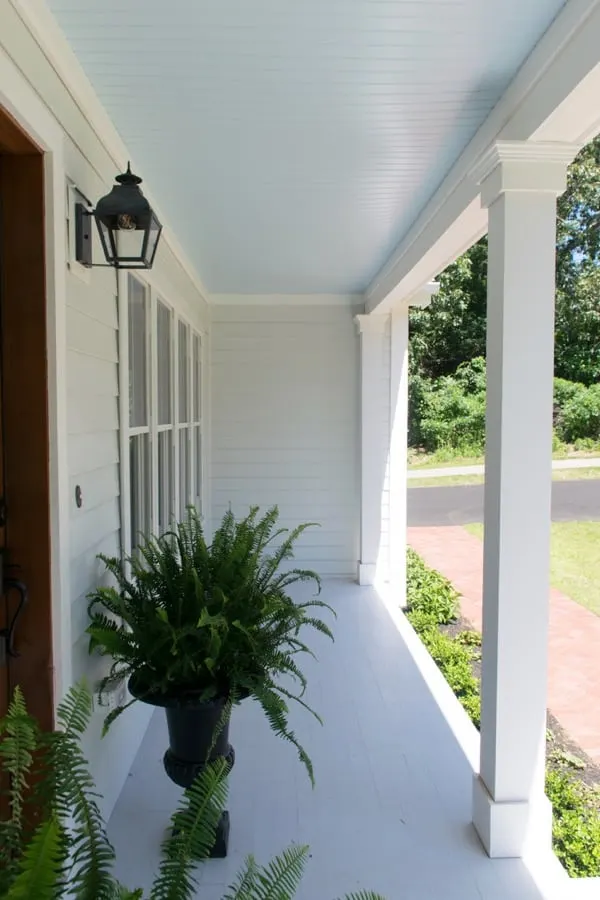 Best haint blue paint colors featuring Sea Salt by Sherwin Williams on a front door porch.  This porch is from the color concierge.