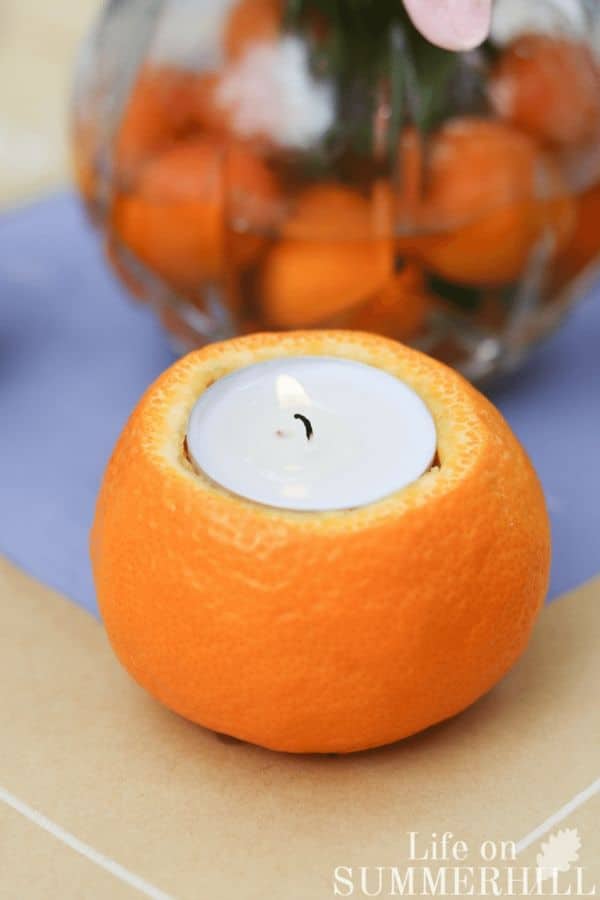 Candle from an orange using a tea light and decorating a table with the orange candles