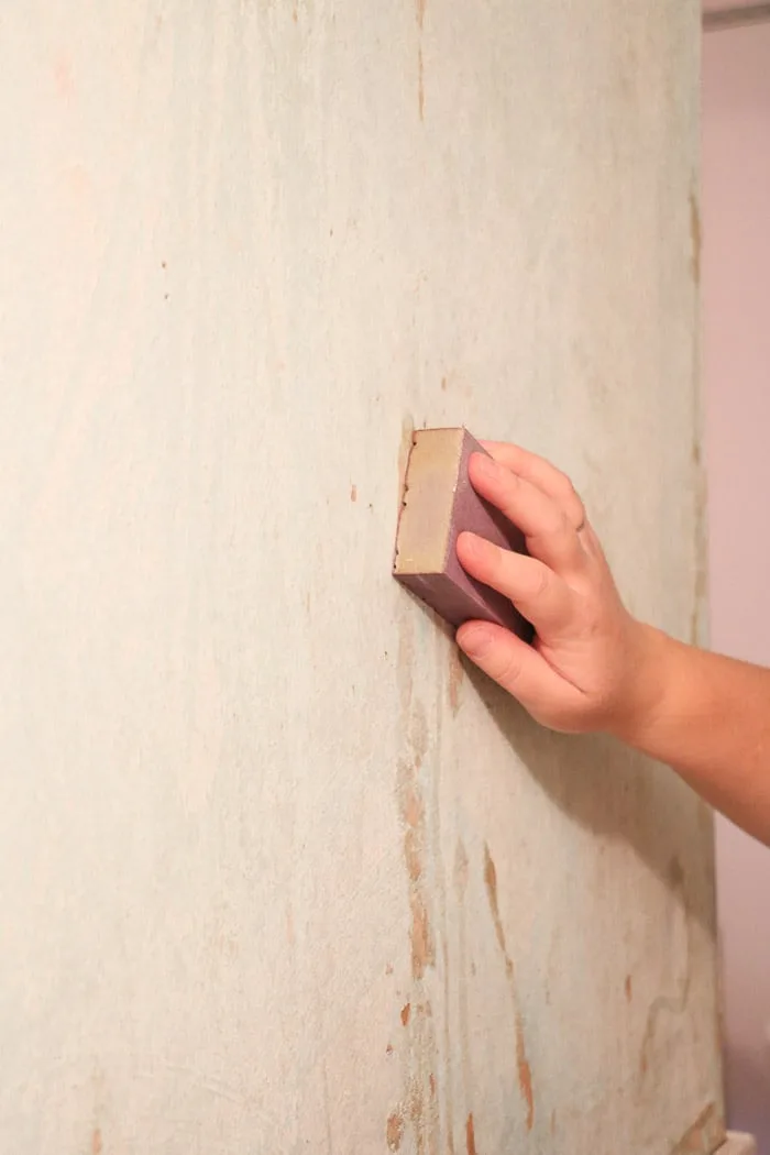 how to remove wallpaper with a steamer and showing how to sand spackled areas and rough areas before painting.