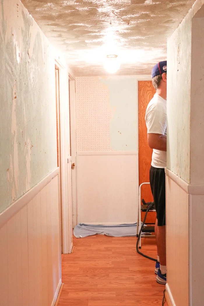 how to remove wallpaper with a steamer.  Removing old wallpaper with a Homeright steamer in a small hallway.