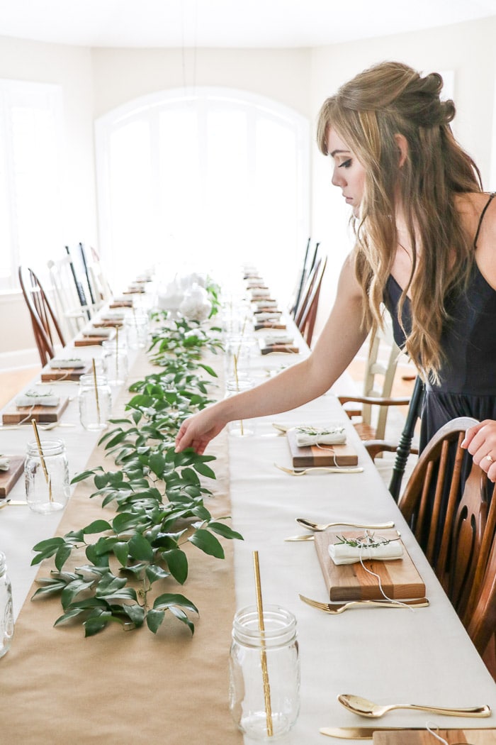 Adding a greenery called smilax that was gathered in the woods along the craft paper runner down the table.  Easy and cheap ideas for nurses graduation party ideas.
