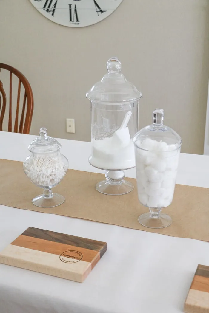 Nurses graduation party ideas using medicinal vintage apothecary jars as the centerpiece.  Fill the jars with doctors office items like cotton balls and epson salt.  Place the jars staggered like in this photo or in a straight row.