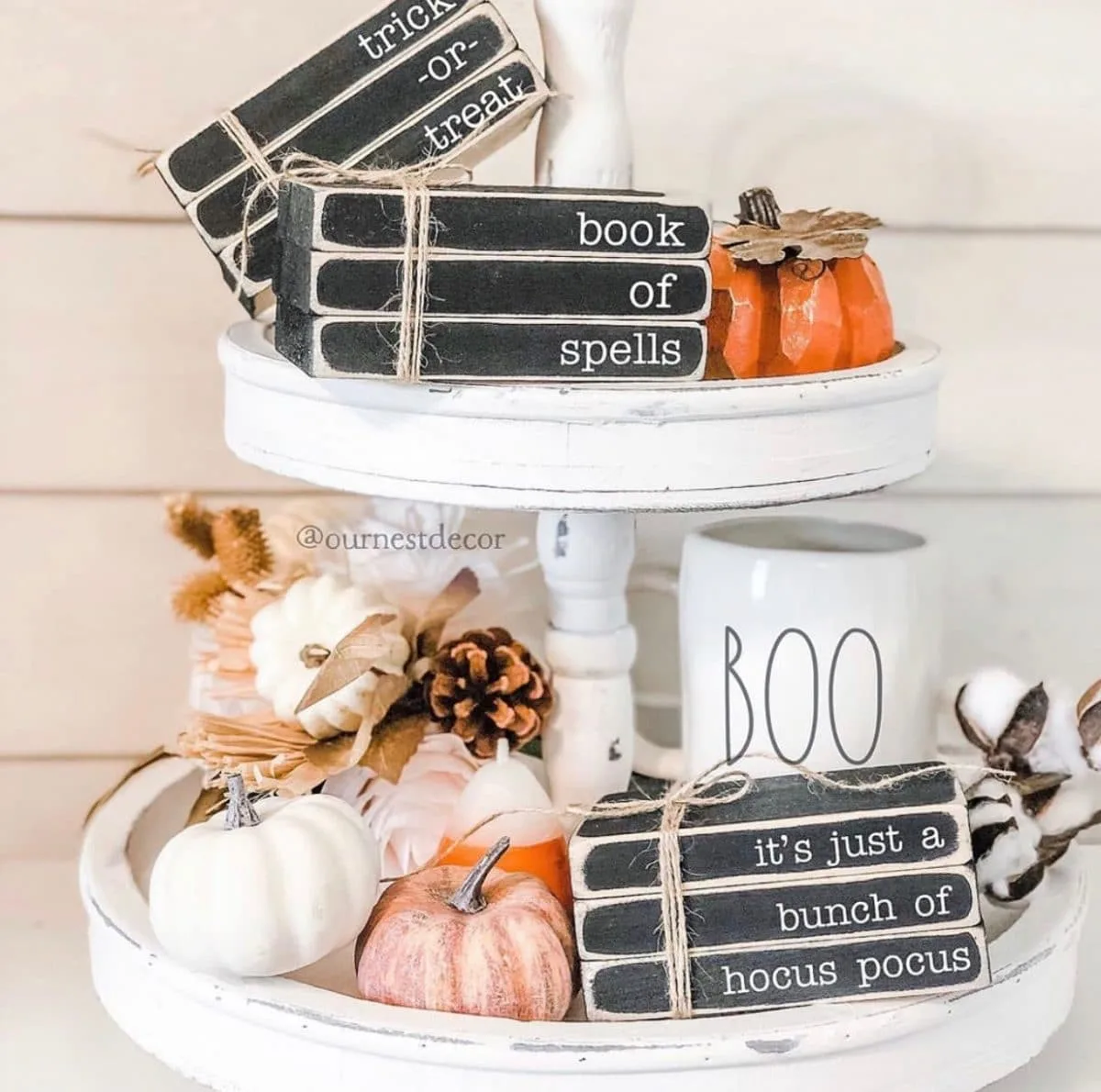 Halloween tiered tray ideas for home.  Pumpkins, pinecones, cotton, boo Rae Dunn mug and wooden books with saying like It's just a bunch of hocus pocus