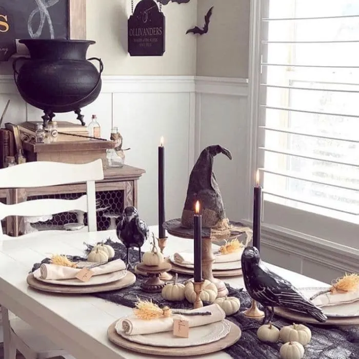 Halloween Table Decorations by Sweet Rose & Wren with a Halloween table complete with pumkins, witches brooms, crows and a witch hat