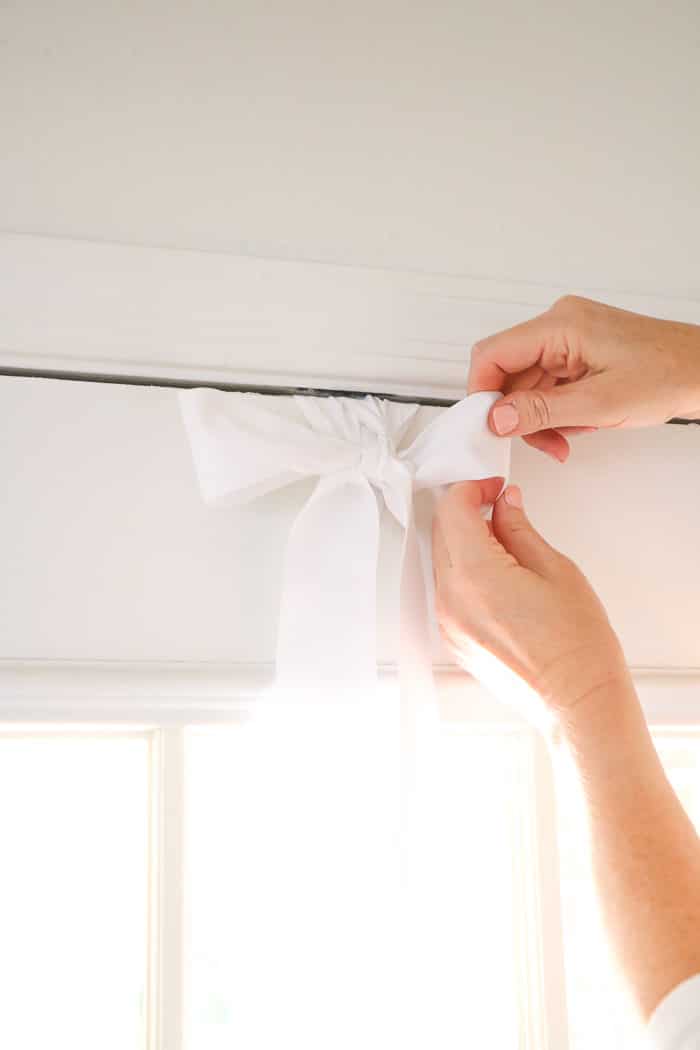 How to hang a wreath with ribbon on a front door while i fluff the ribbon