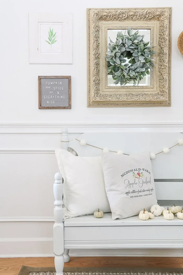 Fall decor with a gallery wall in the entryway, pillows, pumpkins, baskets and more.