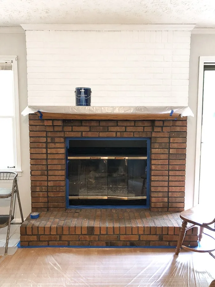 How to paint fireplace bricks.  Paint in sections especially if you are painting by yourself.  Here is the top section painted white and the bottom will come after a break.