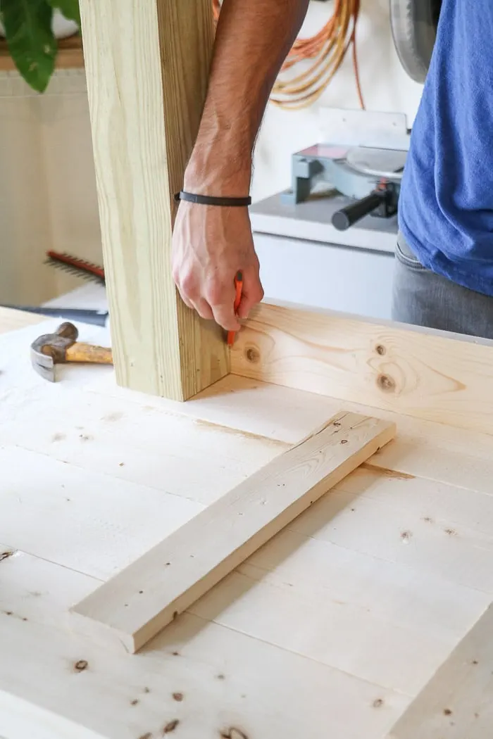 How to build a farmhouse table. Sit apron board again legs and mark for cutting.
