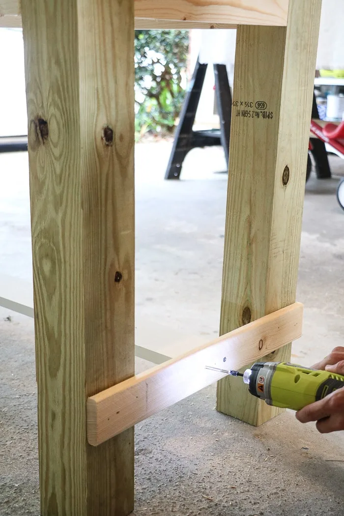 How to build a farmhouse table. Screw in center board to brace.