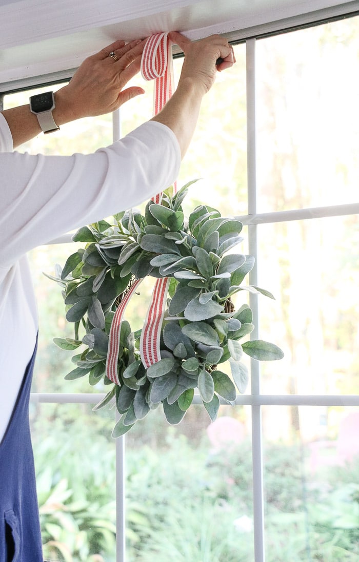 How to hang wreath with ribbon on a window draw the ribbon up to the trim
