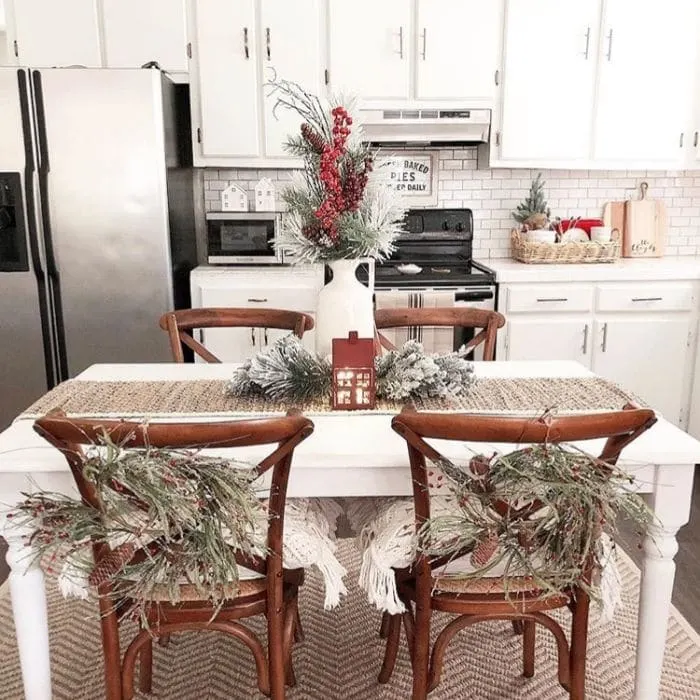 Christmas Kitchen Decor by Angela Hodges Abode with wreaths hanging on chairs at Christmas time