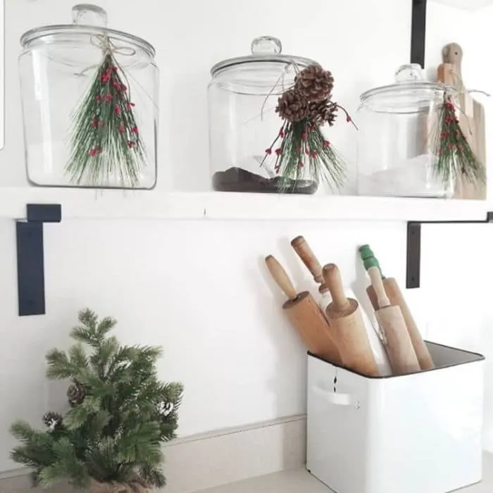 Christmas Kitchen Decor by Rusty 7's with greenery, holly and pine cones hanging on jars