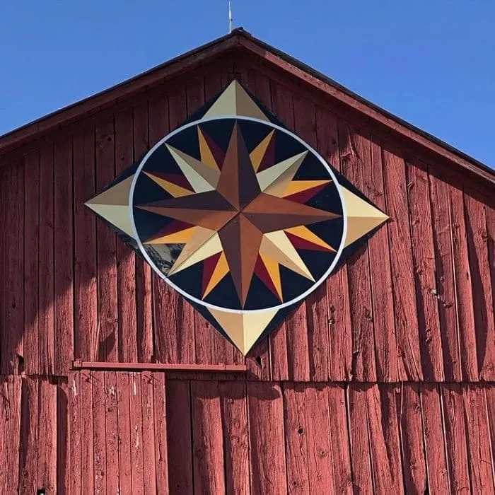 Decorating With Barn Quilts by 100 Acres Of with a barn quilt hanging on a barn