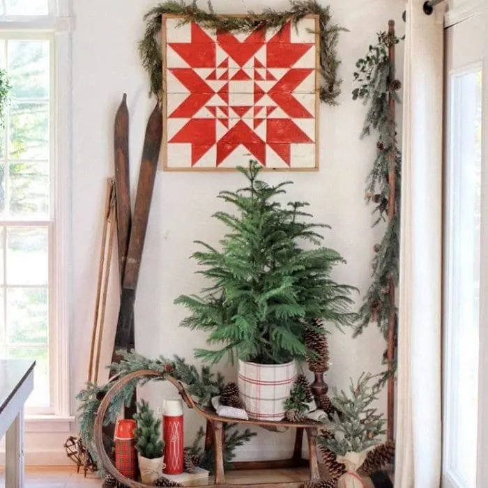 Decorating With Barn Quilts by Baker Nest with a barn quilt hanging in a corner with Christmas decor