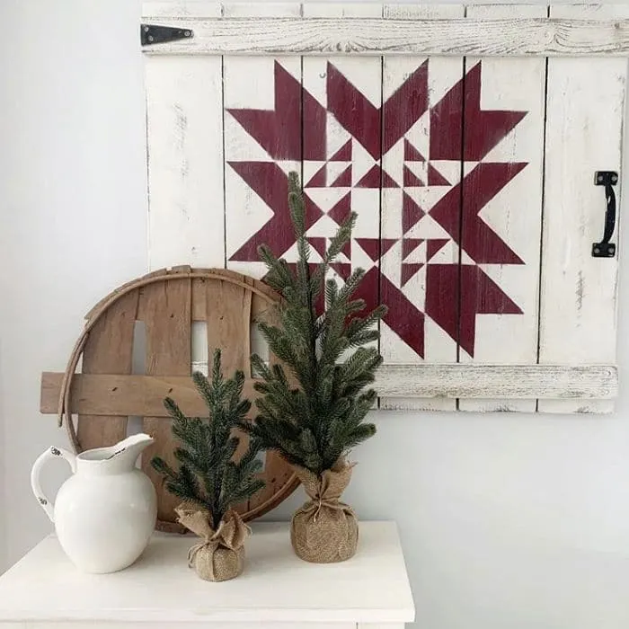 Decorating With Barn Quilts by The French Farmhouse with a Christmas vignette including a barn quilt