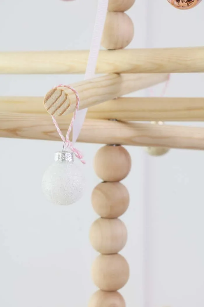 Wooden dowel Christmas tree designed for the kitchen with gingerbread ornaments.