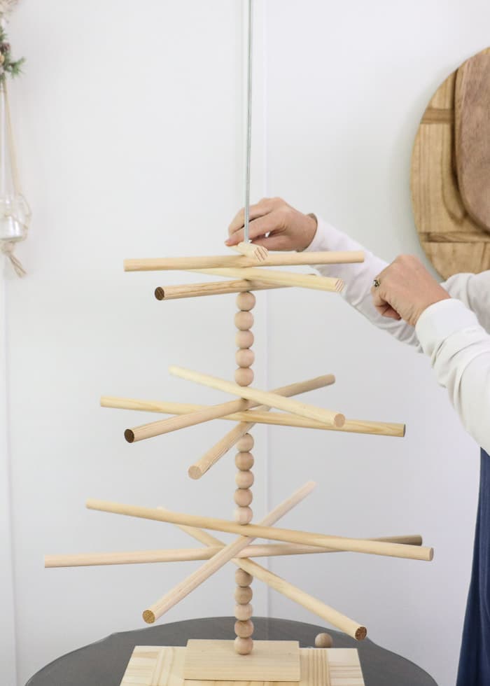 Wooden dowel Christmas tree designed for the kitchen with gingerbread ornaments. Then wooden dowels