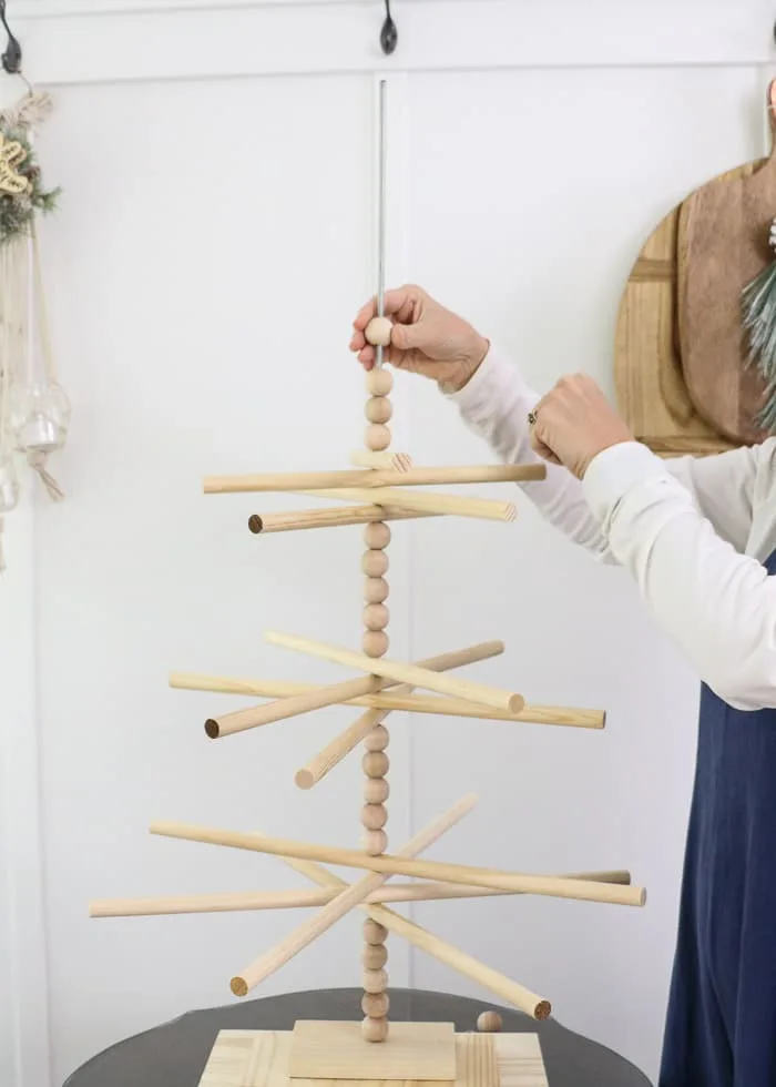 Wooden dowel Christmas tree designed for the kitchen with gingerbread ornaments. Then wooden balls
