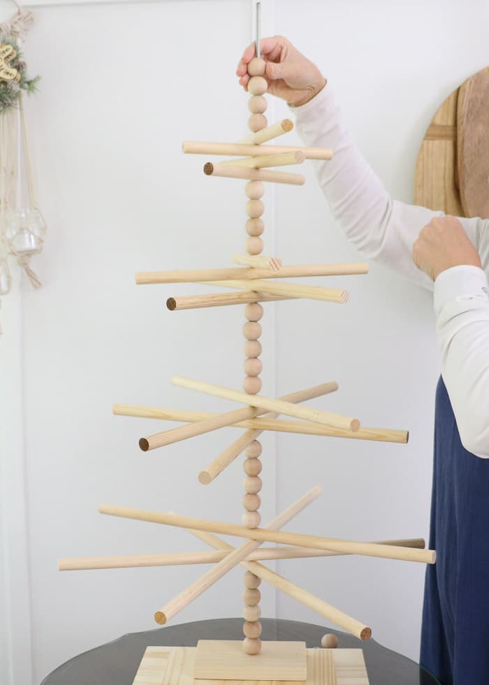 Wooden dowel Christmas tree designed for the kitchen with gingerbread ornaments.  Add more wooden balls