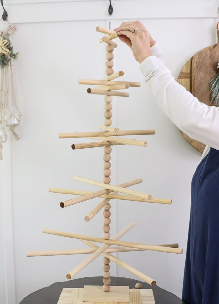 Wooden dowel Christmas tree designed for the kitchen with gingerbread ornaments. Add more wooden dowels