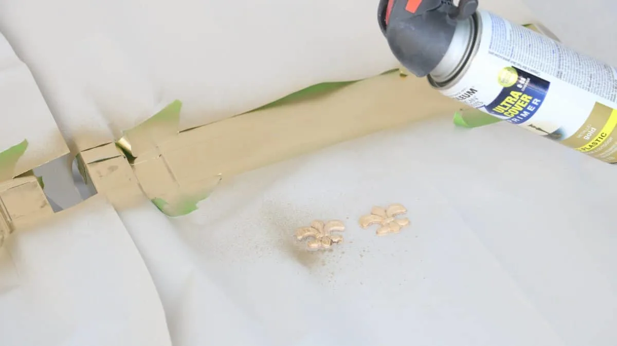 DIY life size nutcracker by painting little fleur de lie pieces with gold