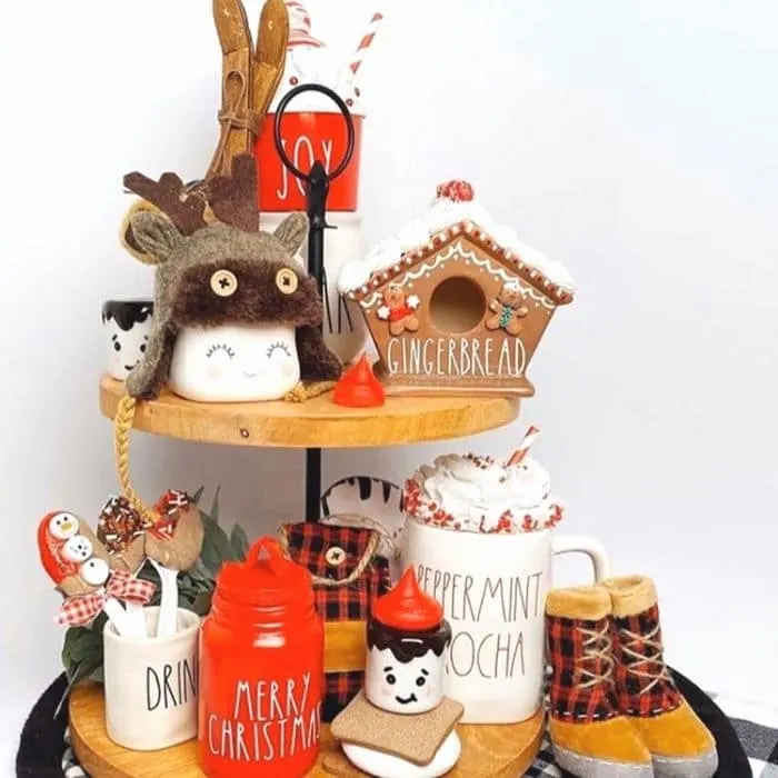 Decorating With Gingerbread Houses by Buttermilk Chic By Wendy with a gingerbread house on a tiered tray with lots of other goodies