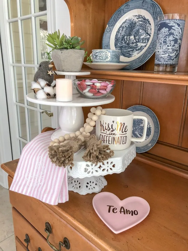 Styling tiered trays with cake stands layered and filled with Valentine decor,