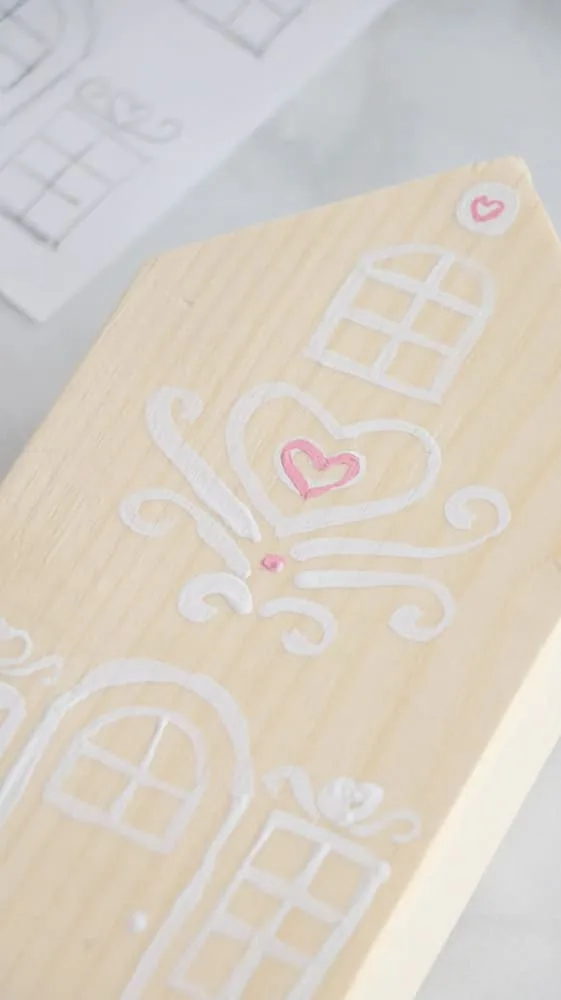 Paint pink hearts and some dots on your 2 x 4 Valentine wooden gingerbread houses