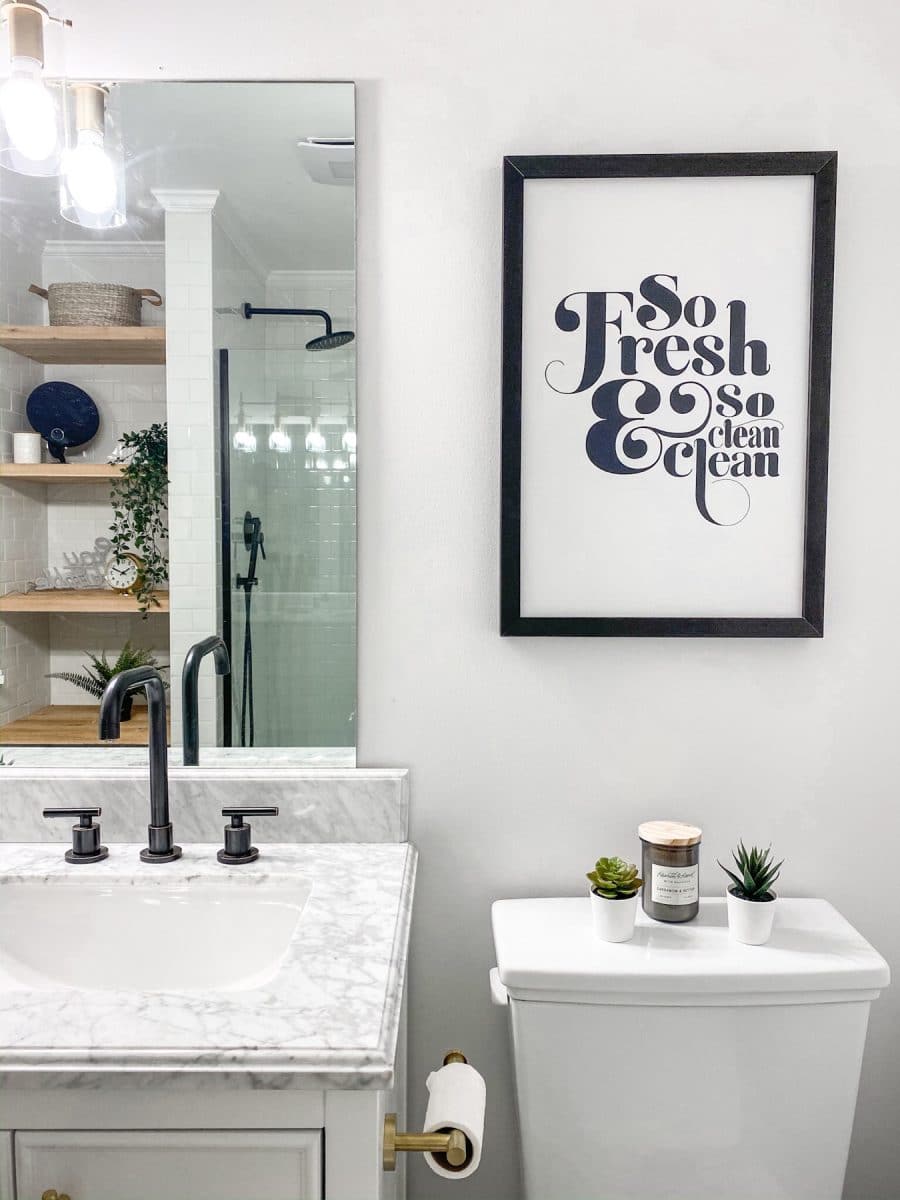 Small farmhouse bathroom ideas using a Smallwood Home art So Fresh and So Clean art.  