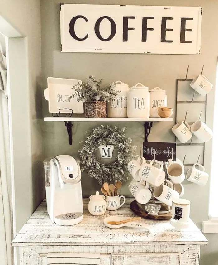 A rustic coffee bar with Rae Dunn pieces and a mug rack and mug tree from Little House on Prairie Cove