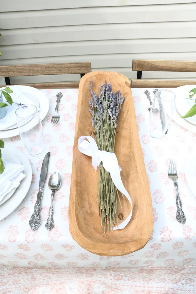 French country table setting centerpiece of lavender in a dough bowl