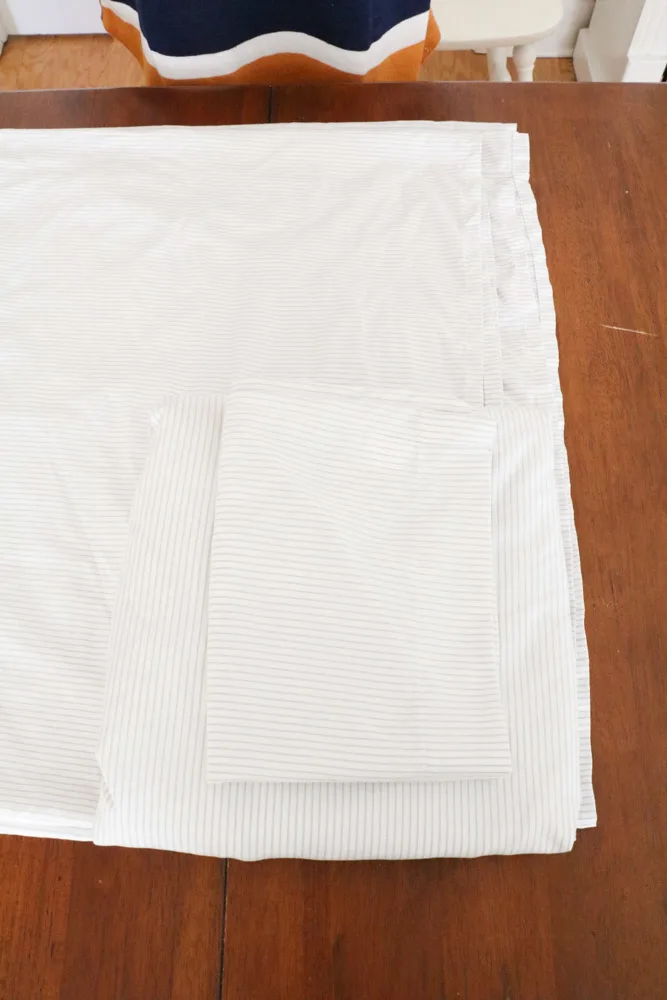 How to fold bed sheets neatly by sitting the pillowcase on top of the fitted sheet.