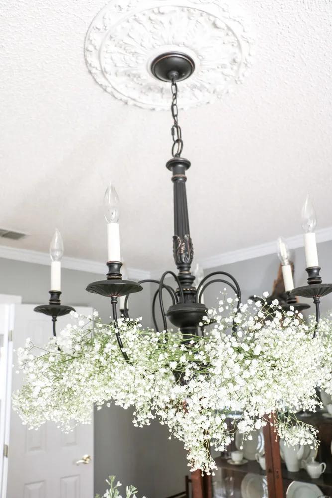 Flower arrangement on a chandelier of baby's breath for a Southern bridal shower.