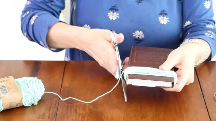 How to make a tassel with yarn by cutting the yarn once you finish wrapping the book
