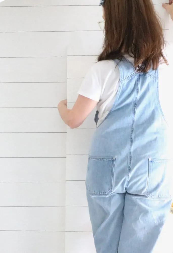 How to install peel and stick wallpaper on an accent wall with a shiplap wall covering.