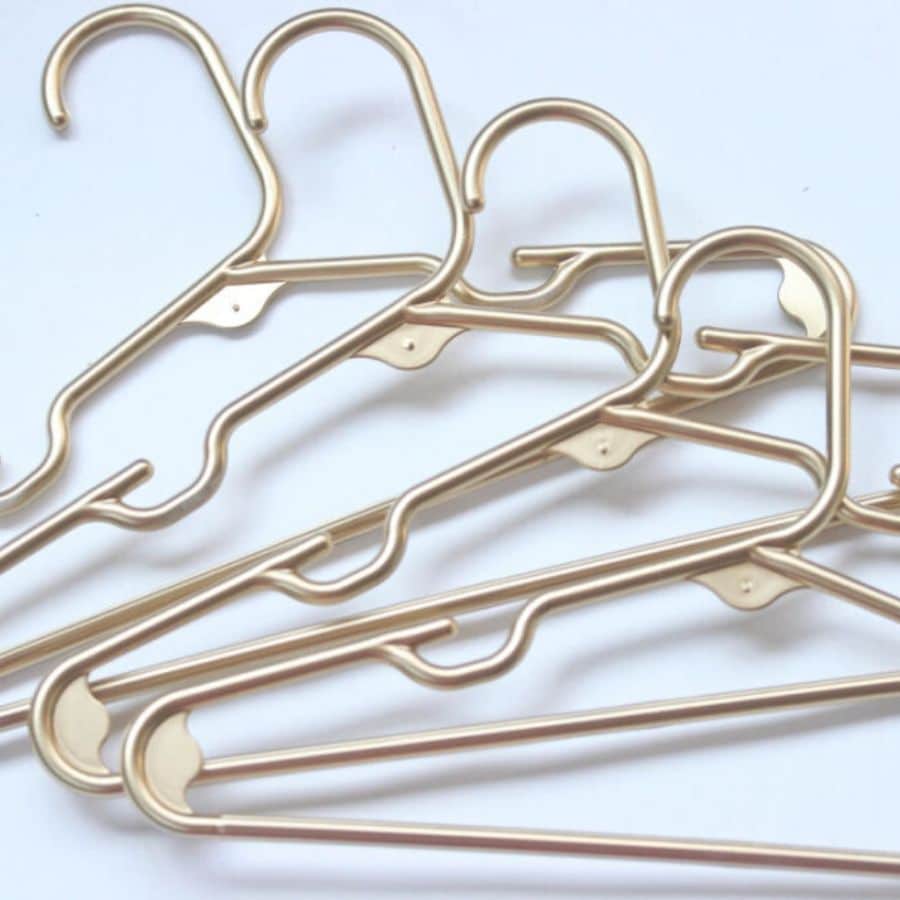 DIY gold plastic hangers by Unlikely Martha