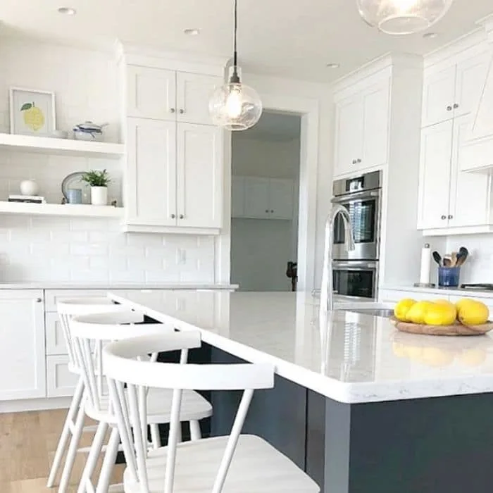 Sherwin Williams Pure White on cabinets and Cyberspace on the island by Kylie M. Interiors