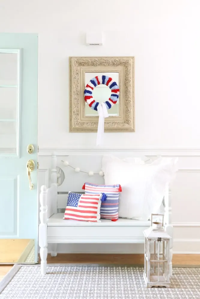 Easy wreath decorating ideas with a red, white and blue wreath on a mirror for 4th of July
