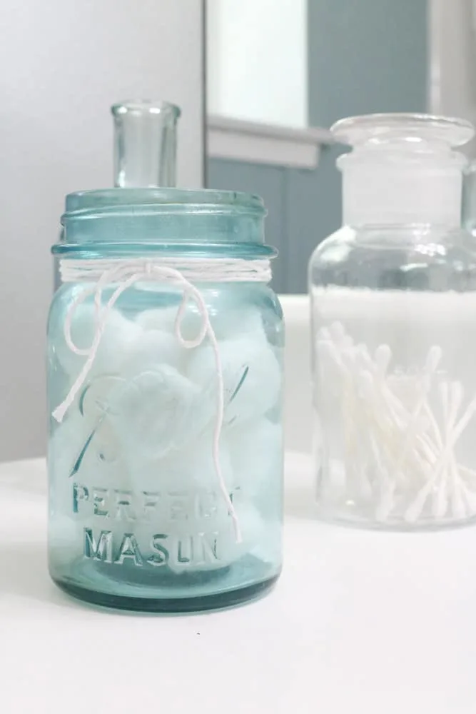 Antique blue mason jar filled with cotton balls