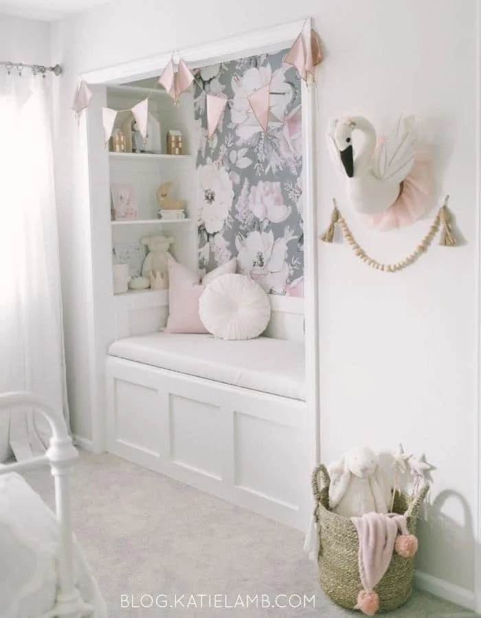 Toddler girl bedroom with a reading nook by Katie Lamb