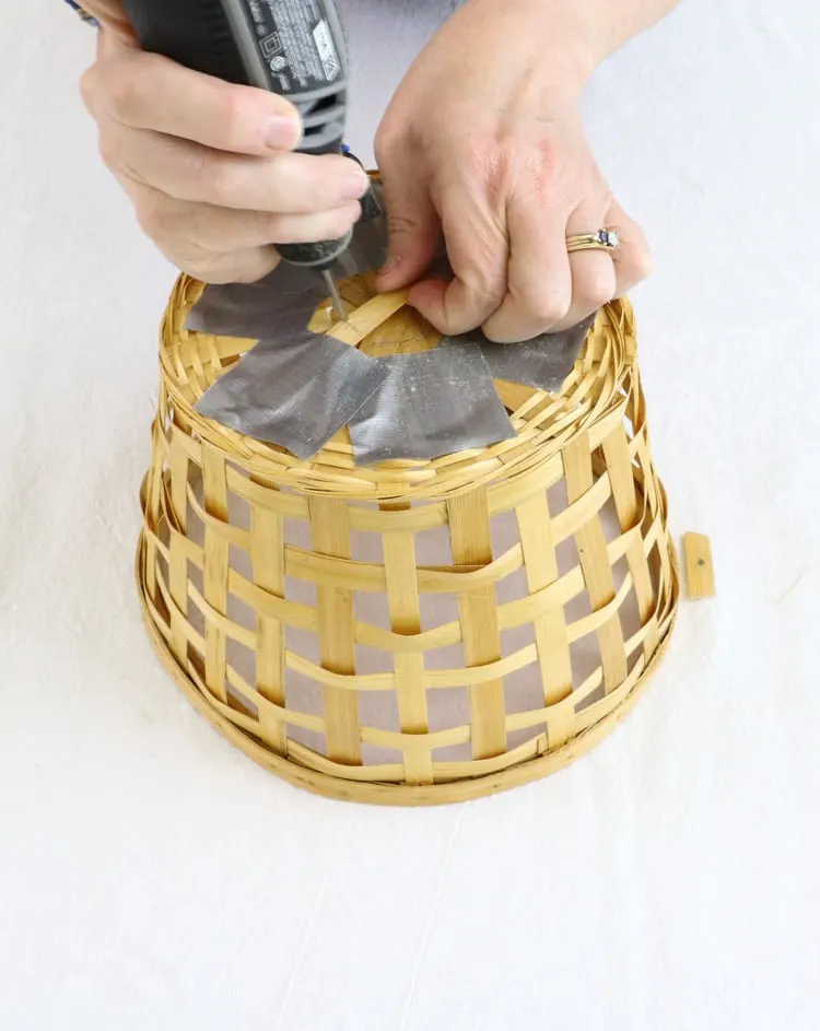 DIY basket ceiling light project using a Dremel to make a hole in the bottom of the basket.