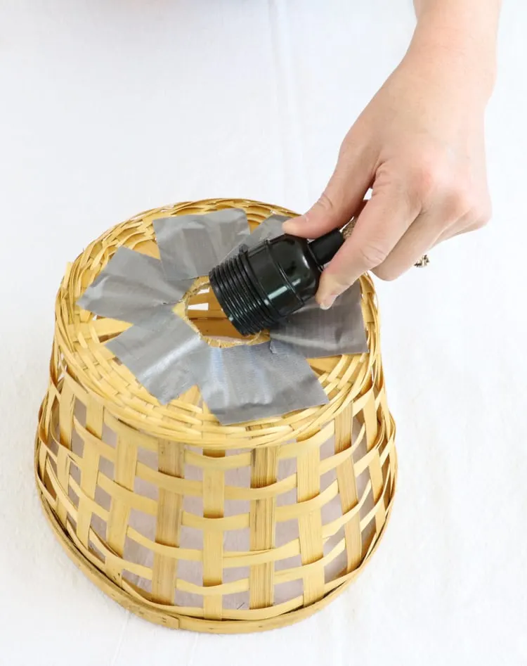 DIY basket ceiling light attaching a light to the bottom.