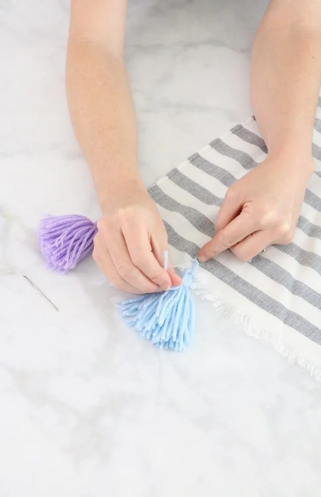 Adding rainbow colored tassels to a blanket