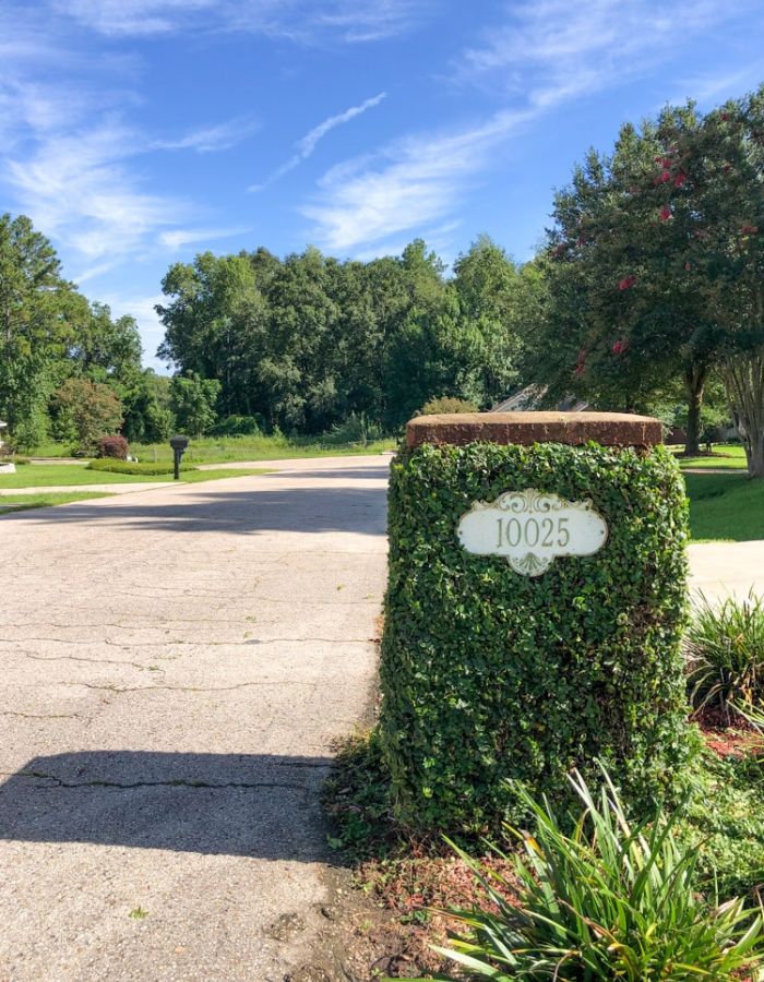 Ivy-covered brick mailbox viewed from the street after a fresh trim