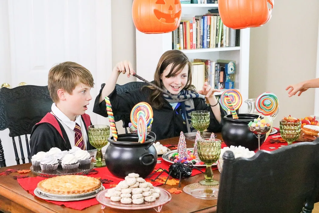 Super easy and fun Hogwarts Halloween inspired Harry Potter table decorations with lots of candy, floating jack o lanterns and more.