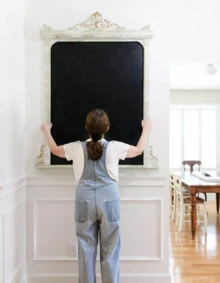 Hanging a frame over a painted home made chalkboard on the wall.