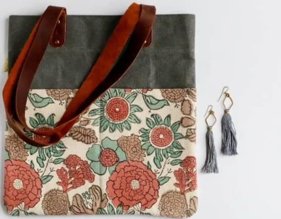 Fair Trade Friday subscription box, Small floral and grey purse with leather straps along with a pair of tassel earrings.