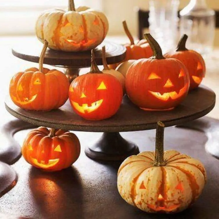 Better Homes and Garden fun small jack o lanterns sitting on layered cakes stands or tiered tray.