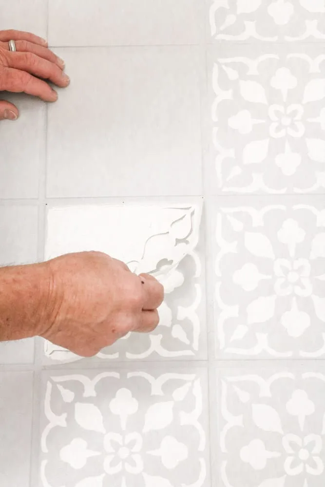 Remove the painted stencil from the tile floor