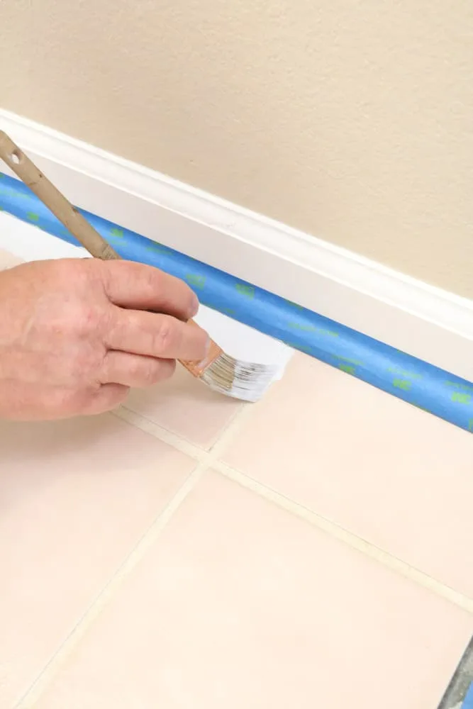 Paint along the edges first when painting ceramic tile floors
